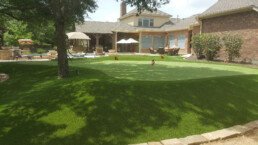 private putting green in backyard of home