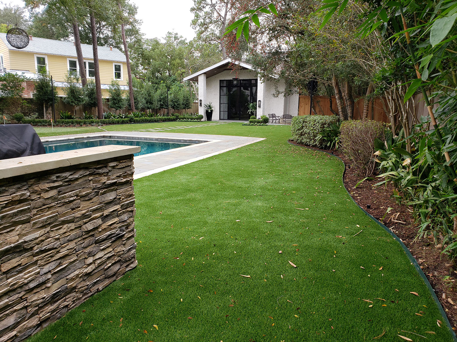 backyard landscaped with artificial grass