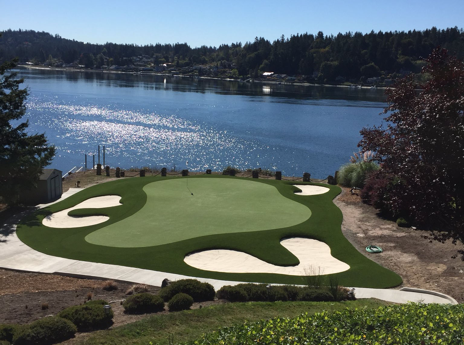 synthetic turf golf green with bunkers on water