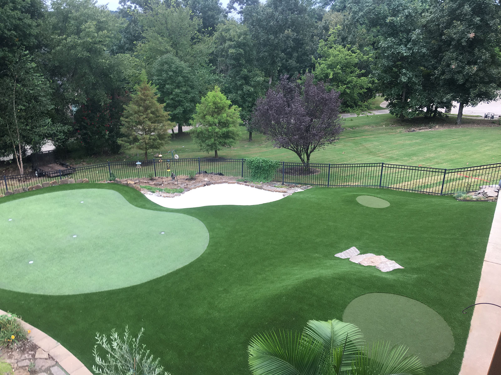 synthetic grass putting green with landscaping